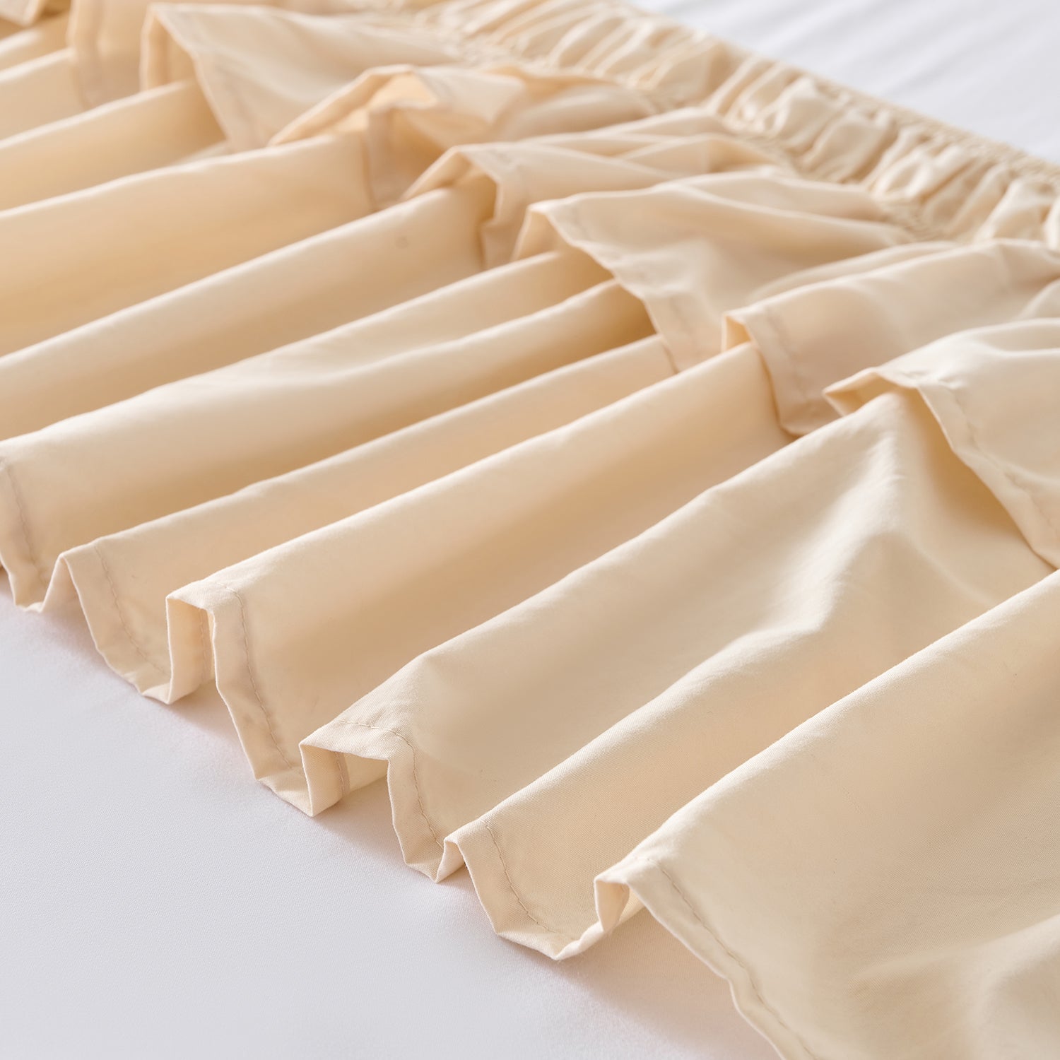 Wrap around elastic bed skirt with modern dust ruffle design for multiple bed sizes